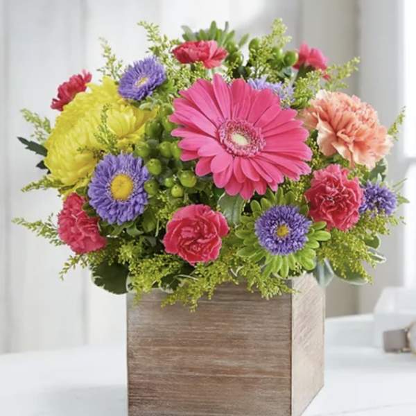Colorful mixed flower arrangement in a wooden box