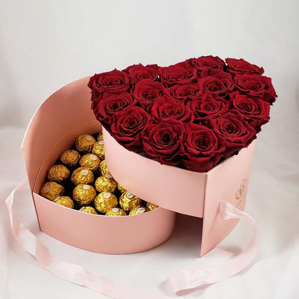 Heart-shaped box with red roses and gold-wrapped chocolates