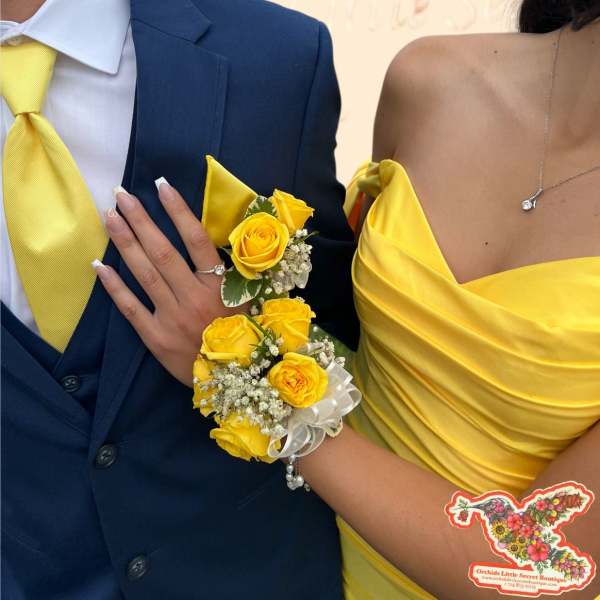 Yellow rose corsage and boutonniere on a couple in formal attire