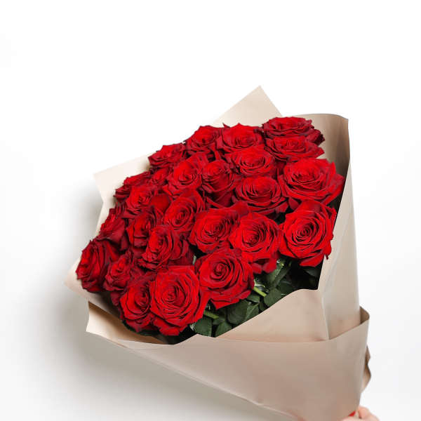 Bouquet of red roses wrapped in beige paper