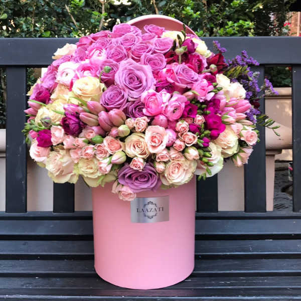 Large pink and lavender rose arrangement in a pink hat box