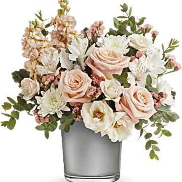 Blush and white floral arrangement in a clear glass vase