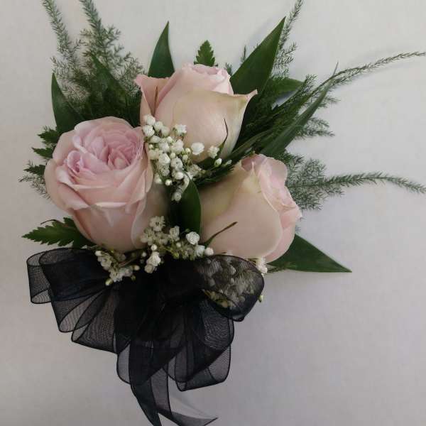 Pink roses with baby's breath and a black ribbon bow