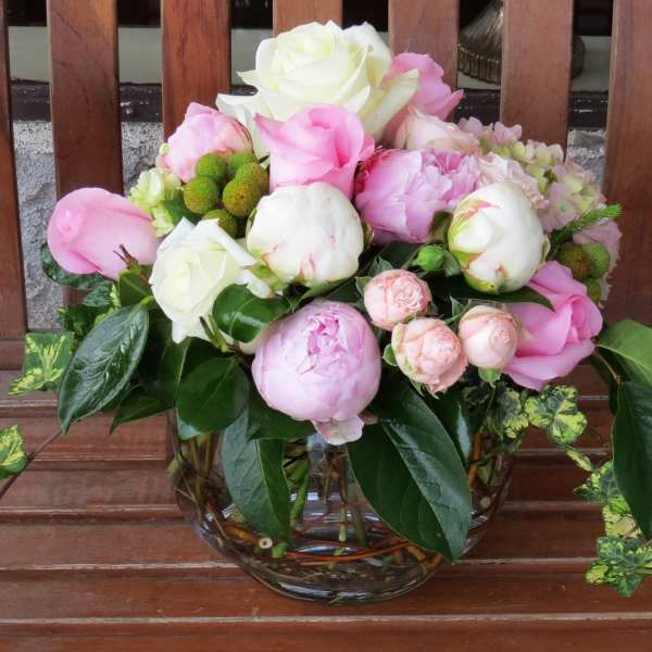 Pink and white flower arrangement in a glass vase