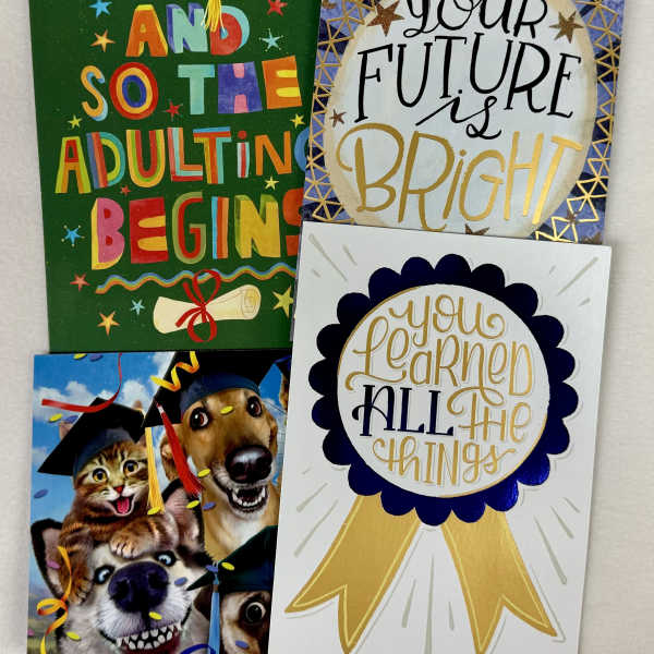 Four graduation-themed greeting cards with caps, ribbons, and celebratory text