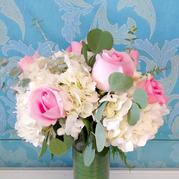 Pink roses and white hydrangeas in a glass vase