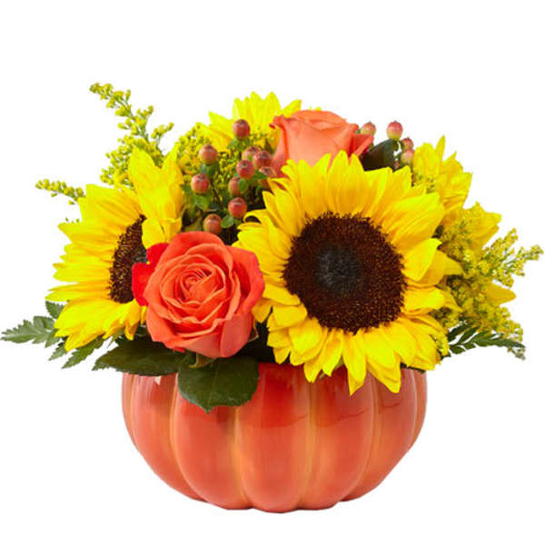 Sunflowers and orange roses in a pumpkin-shaped vase