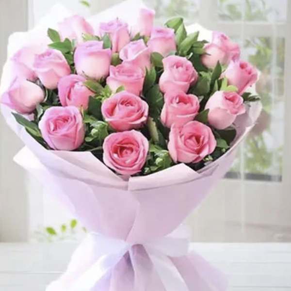 Pink rose bouquet wrapped in pale pink paper
