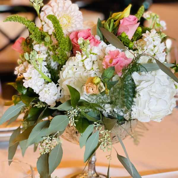 Mixed pink and white floral arrangement in a silver vase