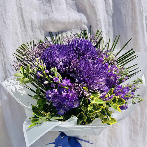 Purple bouquet with hydrangeas and a blue ribbon