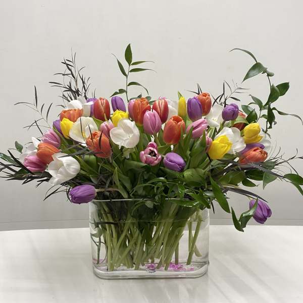 Colorful tulip bouquet in a clear glass vase