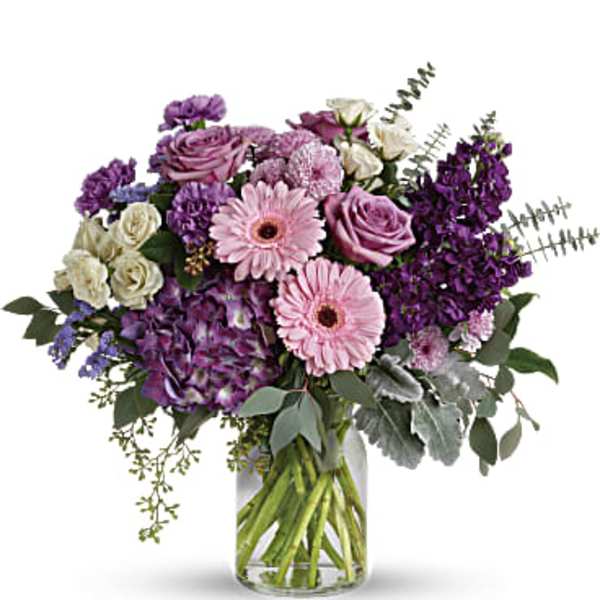 Purple and pink mixed bouquet in a clear glass vase