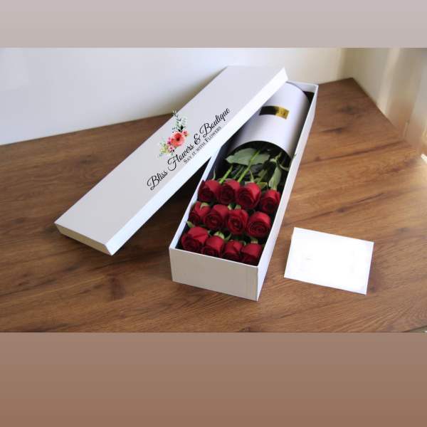 Boxed bouquet of red roses in a white gift box