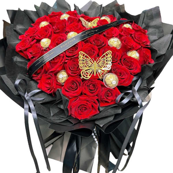 Heart-shaped bouquet of red roses with gold chocolates and black wrapping