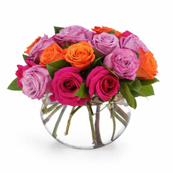 Bouquet of pink, lavender, and orange roses in a clear glass vase