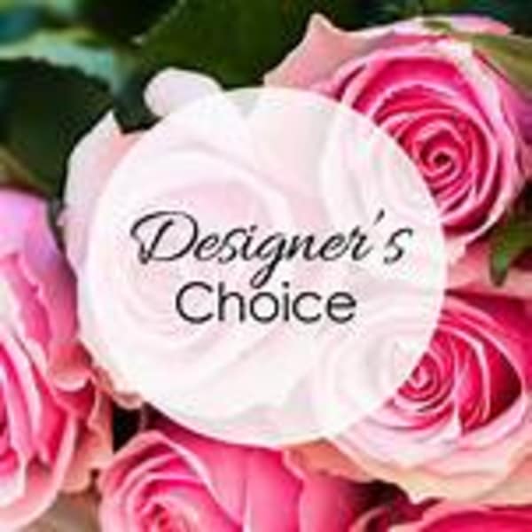 Pink roses with a center label reading "Designer’s Choice"