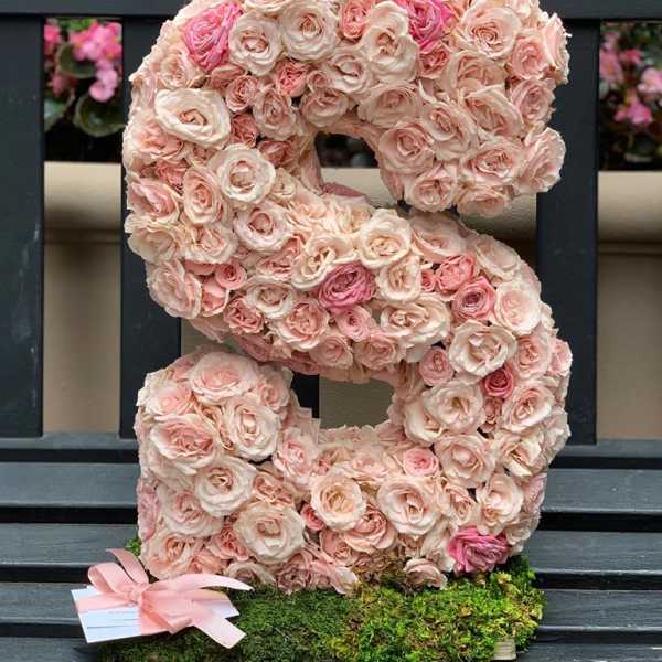 Large floral letter S covered in pale pink roses