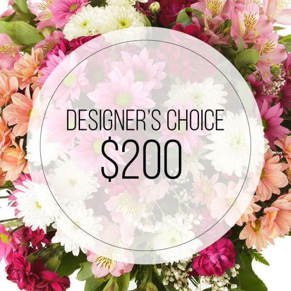 Mixed pink and white flowers surrounding a designer's choice $200 label