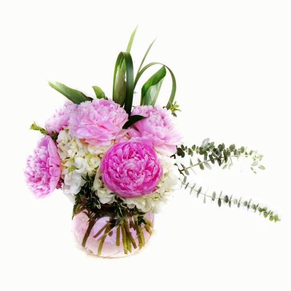 Pink peonies and white hydrangeas in a glass vase