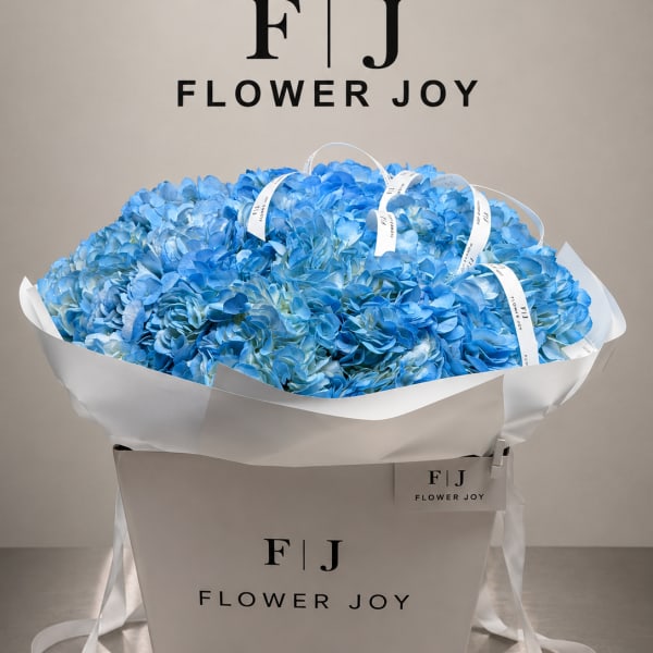 Large bouquet of blue hydrangeas in a white gift box