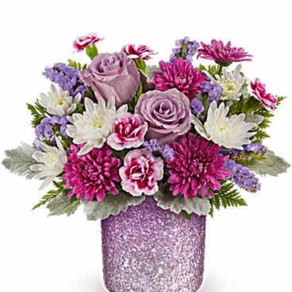 Pink and lavender flowers arranged in a glittery vase