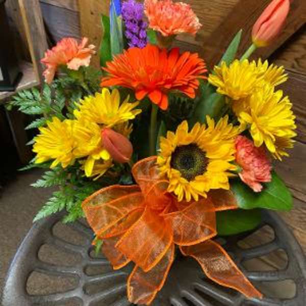 Bright mixed bouquet with sunflowers, gerbera daisies, tulips, and a purple accent flower