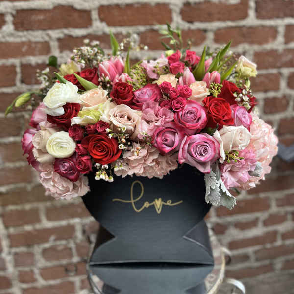 Mixed pink and red rose bouquet in a black box