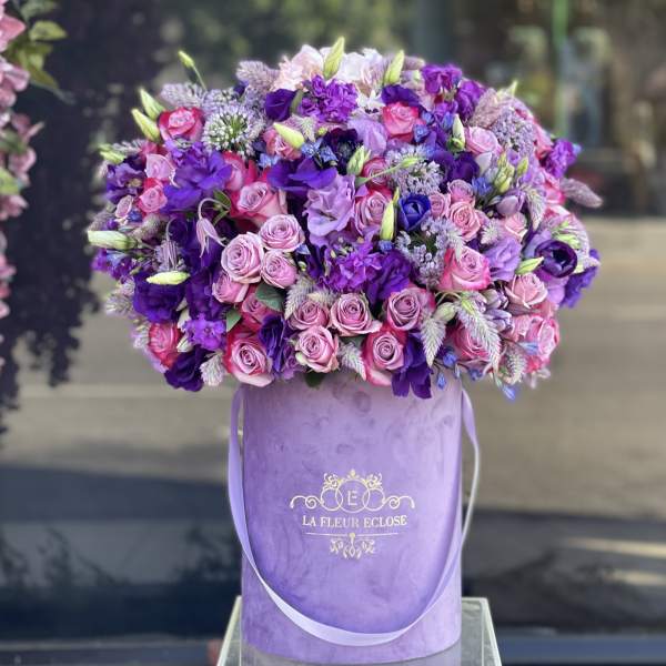 Pink and purple rose bouquet in a lavender hatbox