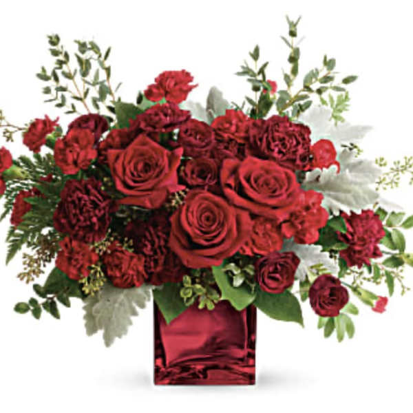 Red roses and carnations in a red glass vase