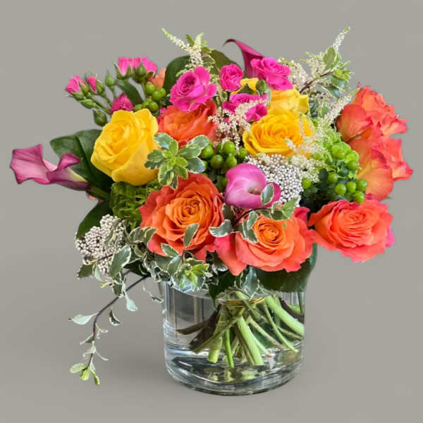 Bright mixed rose bouquet in a clear glass vase