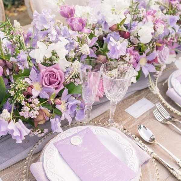 Lavender and white floral table centerpiece with place settings