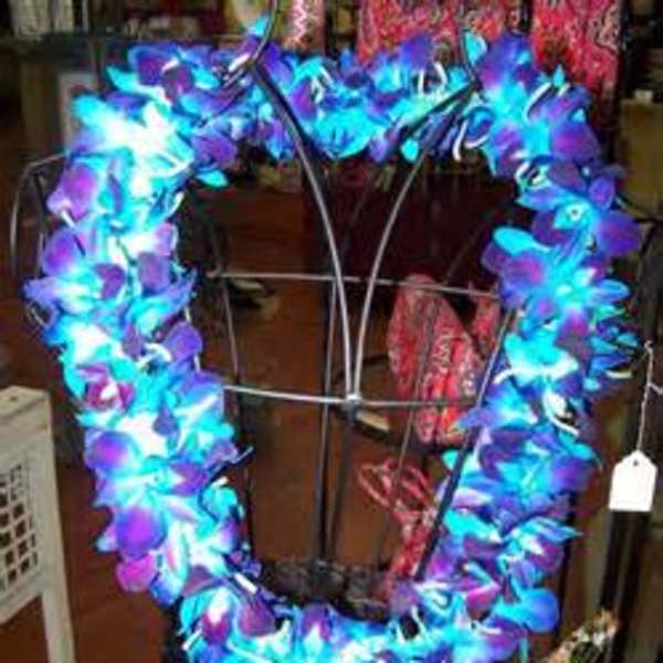 Heart-shaped floral wreath with bright blue and purple flowers