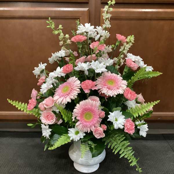 Pink and white mixed flower arrangement in a white vase