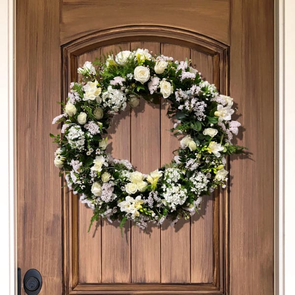 White floral wreath on a wooden door