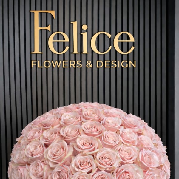 Large dome of pale pink roses in a pink box