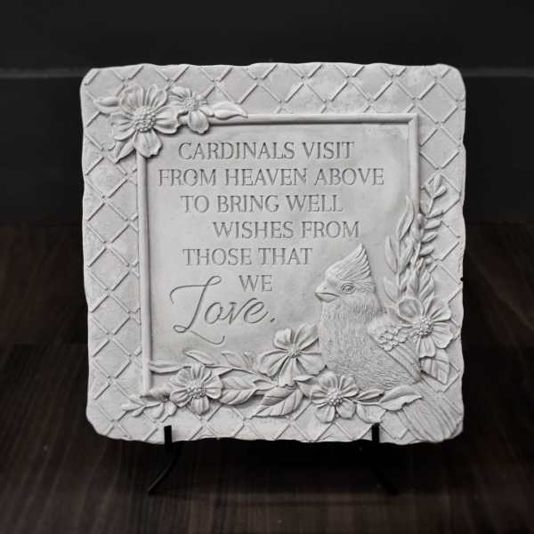 Decorative memorial plaque with a cardinal and floral relief