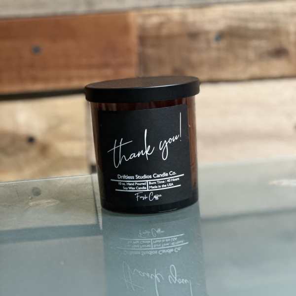 Black jar candle with a "thank you!" label