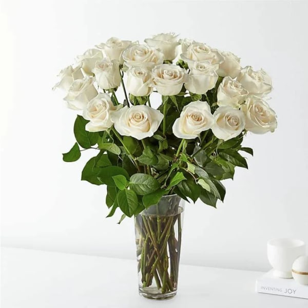 White roses arranged in a clear glass vase