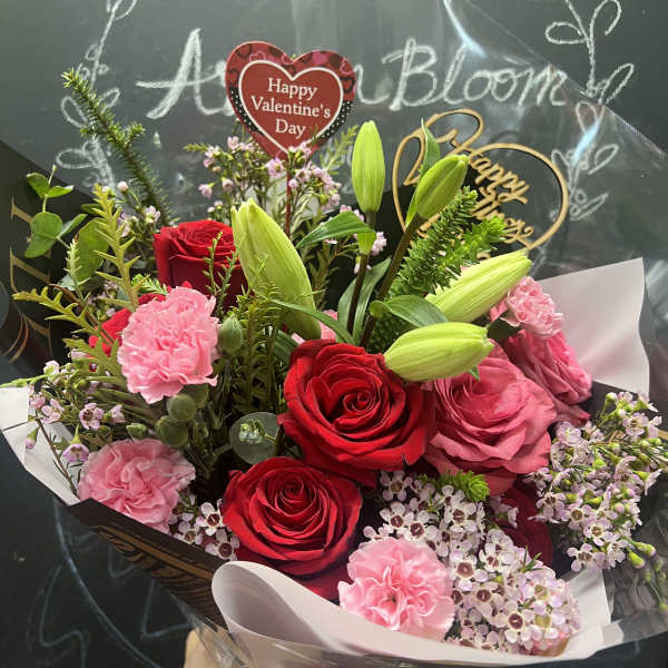 Bouquet of red and pink roses with lilies and carnations