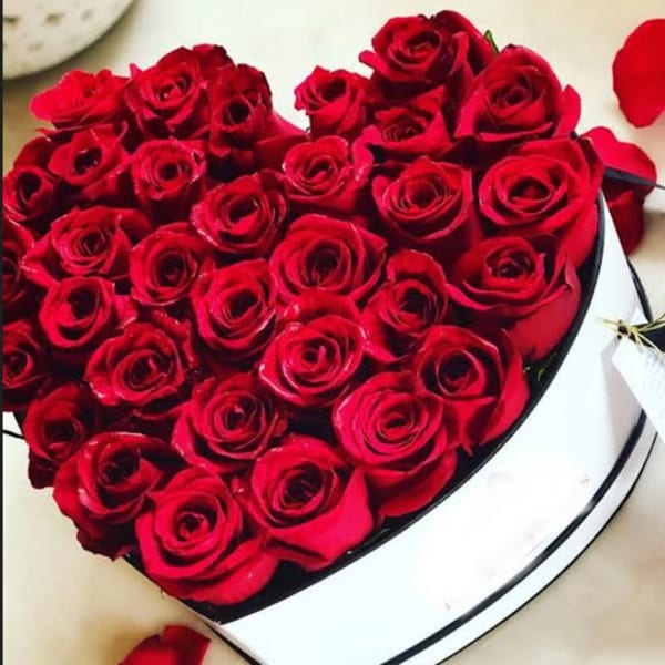 Heart-shaped box filled with red roses