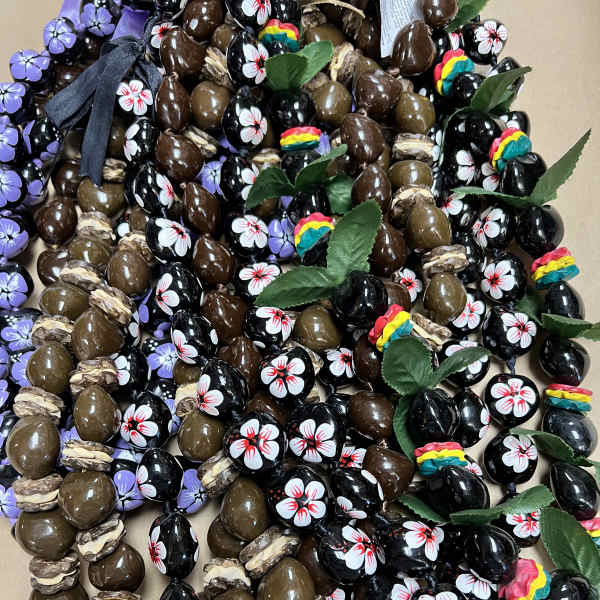 Assorted decorated chocolate candies with ribbon and leaf accents