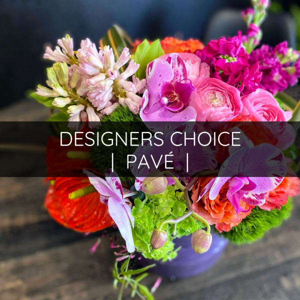 Colorful mixed flower bouquet in a purple vase