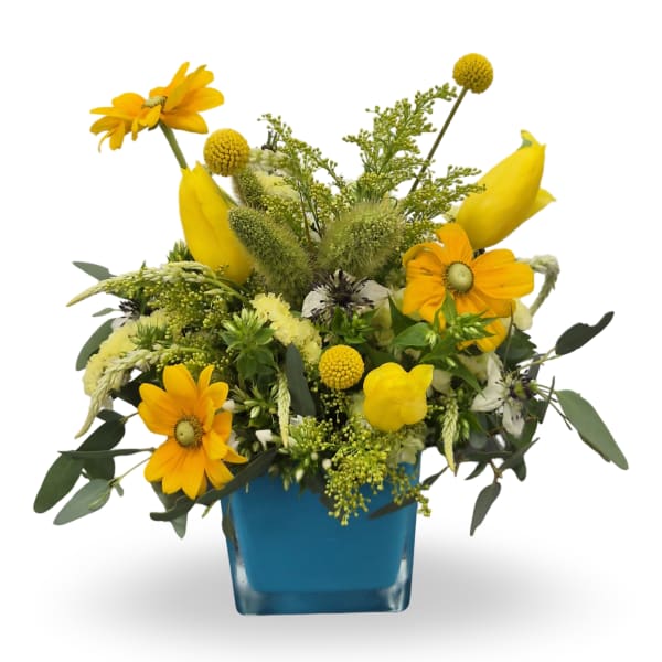 Yellow mixed bouquet in a blue square vase