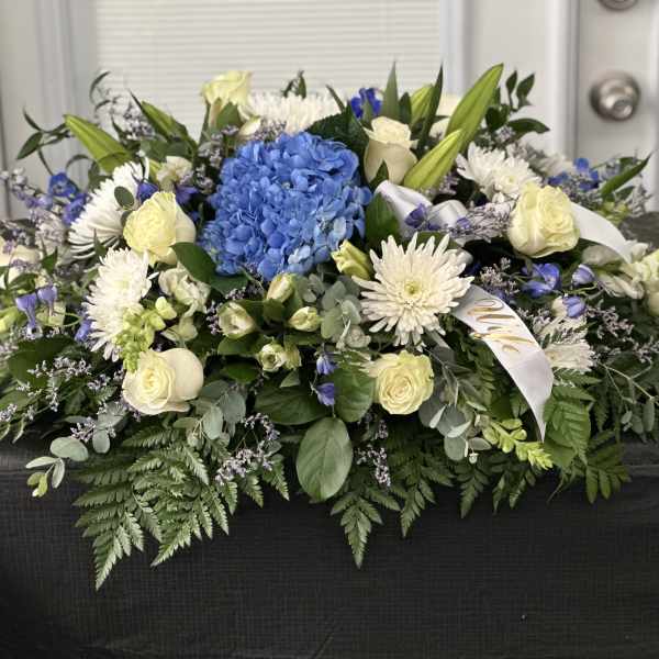 Blue hydrangea and white roses in a low floral arrangement