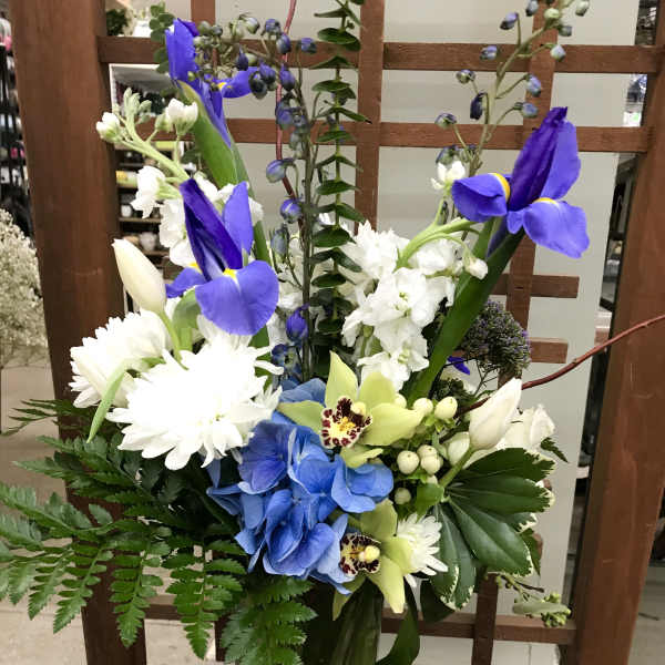 Blue and white floral arrangement in a glass vase