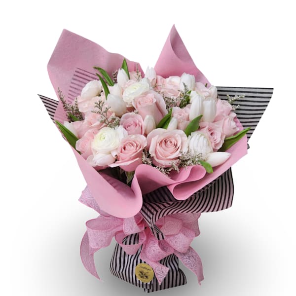 Bouquet of pink and white roses with white tulips wrapped in pink paper