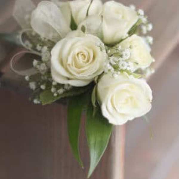 Small bouquet of white roses and a white tulip with greenery