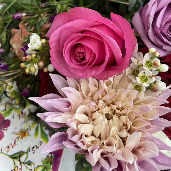Pink rose and pale dahlia bouquet with small white blossoms
