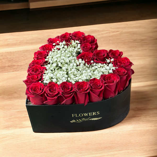 Heart-shaped box of red roses with white baby's breath