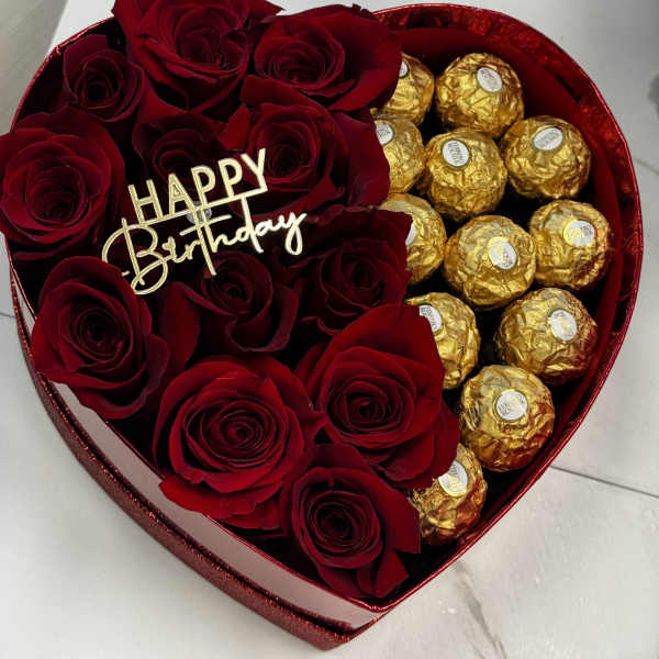 Heart-shaped box with red roses and gold-wrapped chocolates